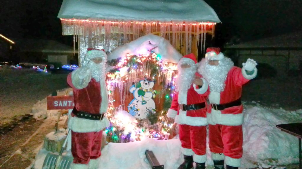 Santas in front of icy Christmas wreath, December 22, 2013